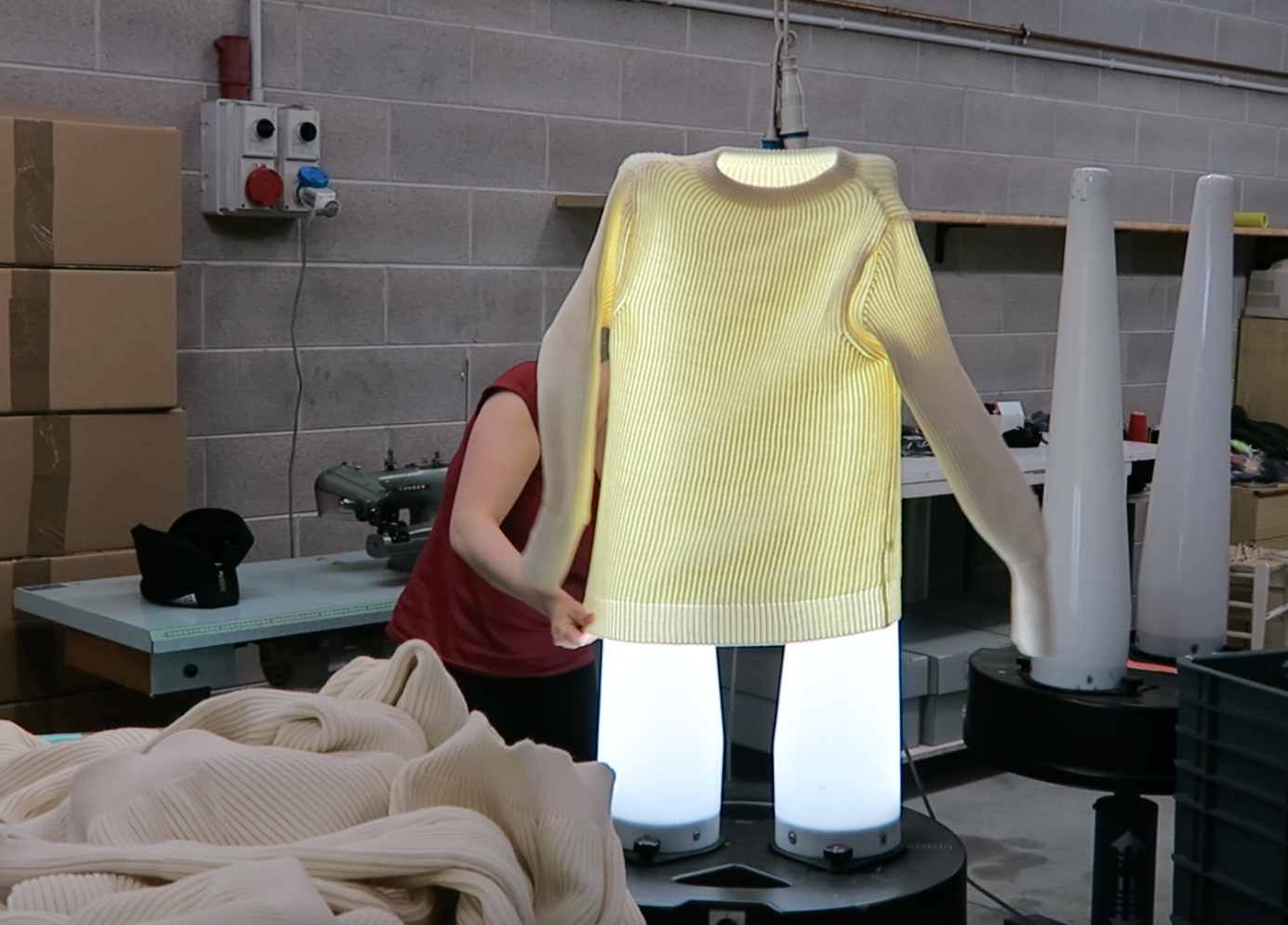 Light testing garments to make sure all is knitted and linked to standards